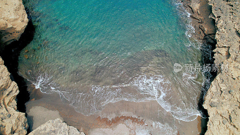 Aerial view of the hidden cove beach "La Rajita" at the natural reserve of "Monta?a Pelada" in Tenerife (Canary Islands). Drone shot